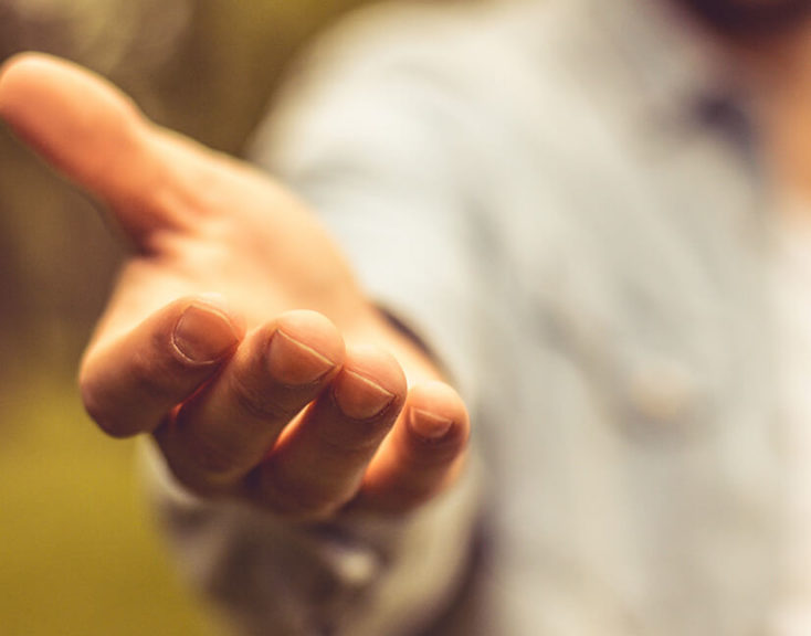 Man with hand extended, palm facing up