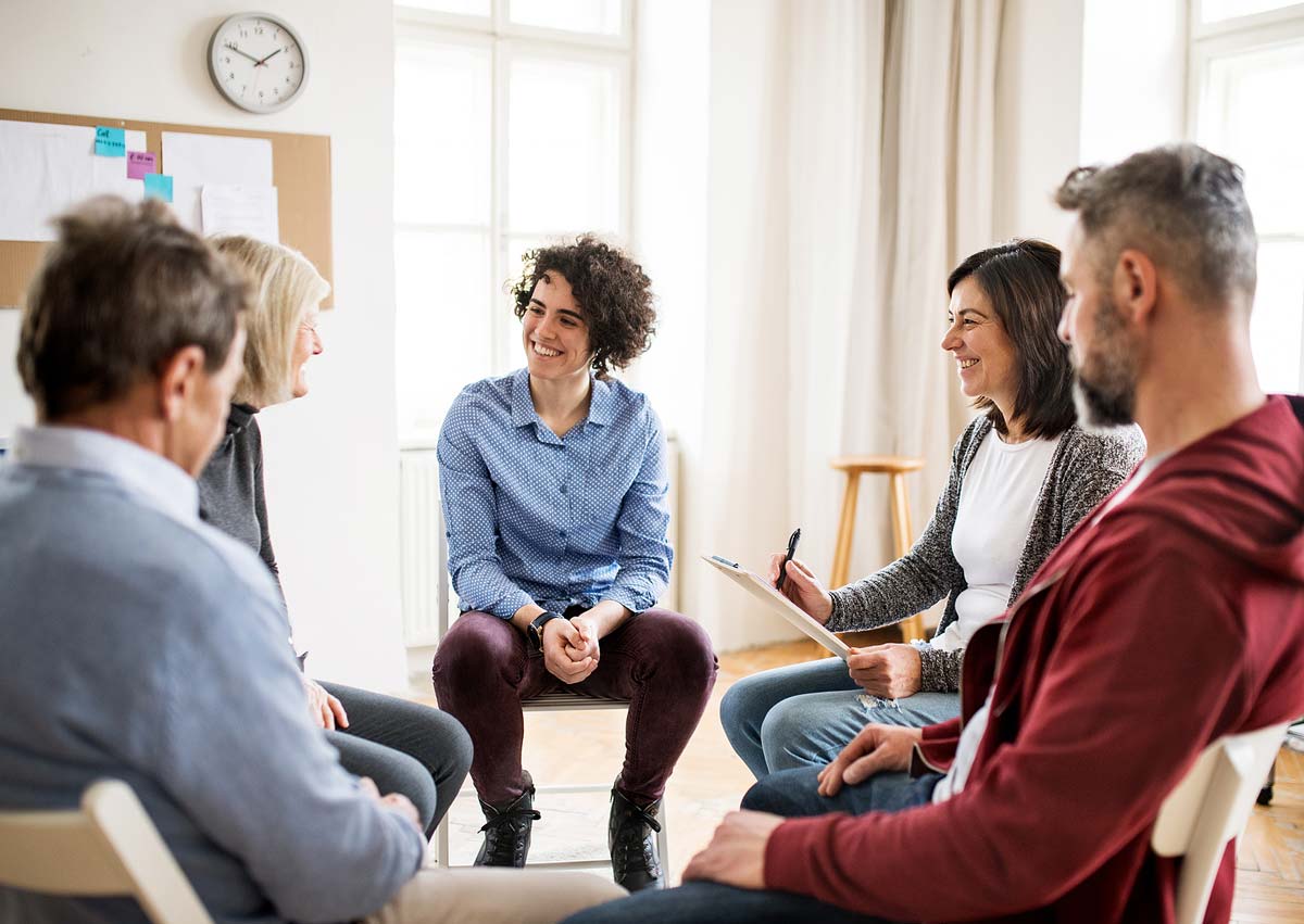 Men and Women sitting in circle